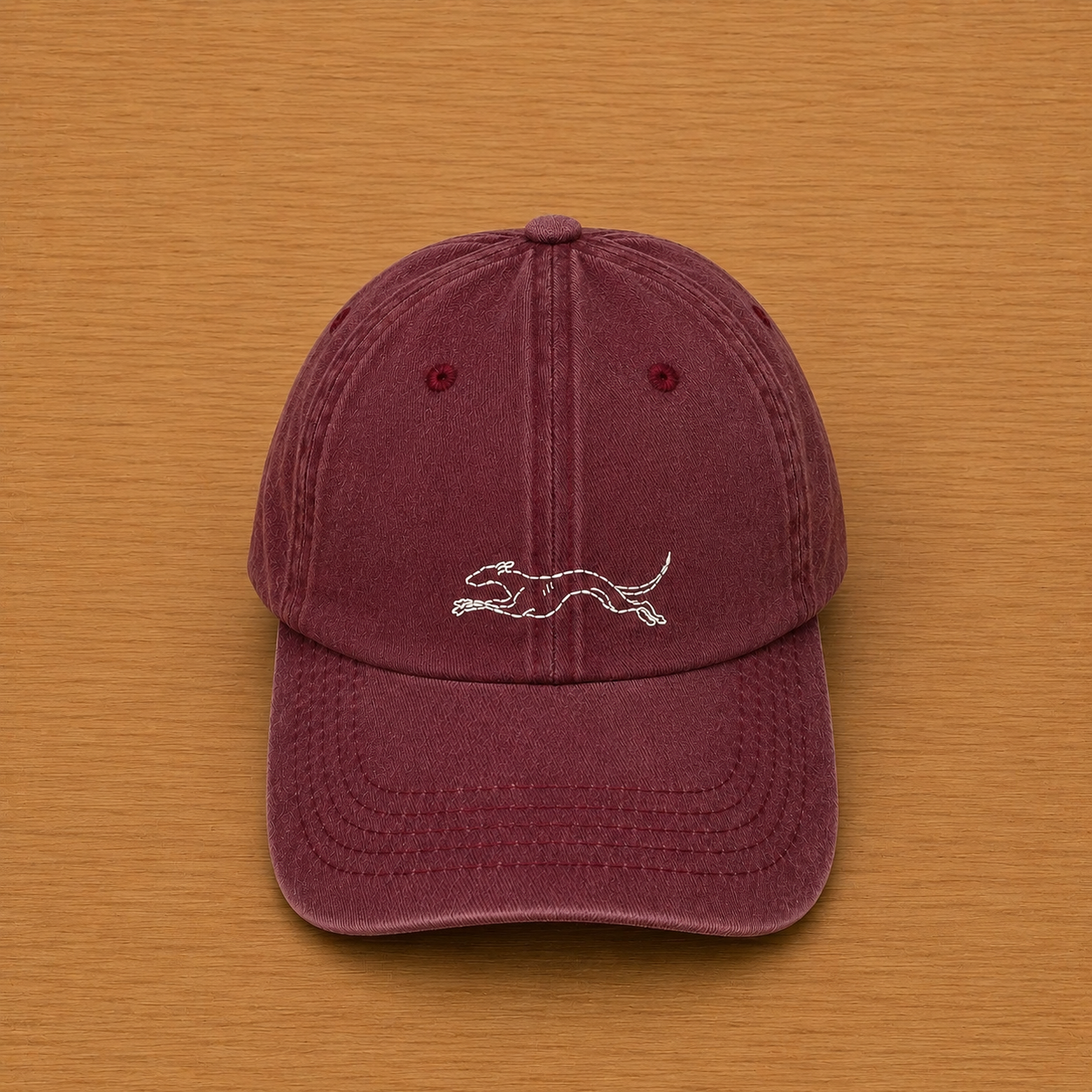 Maroon cap with hand-embroidered running greyhound