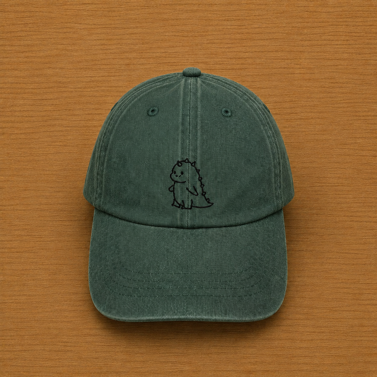 Gorra color verde bosque con dinosaurio