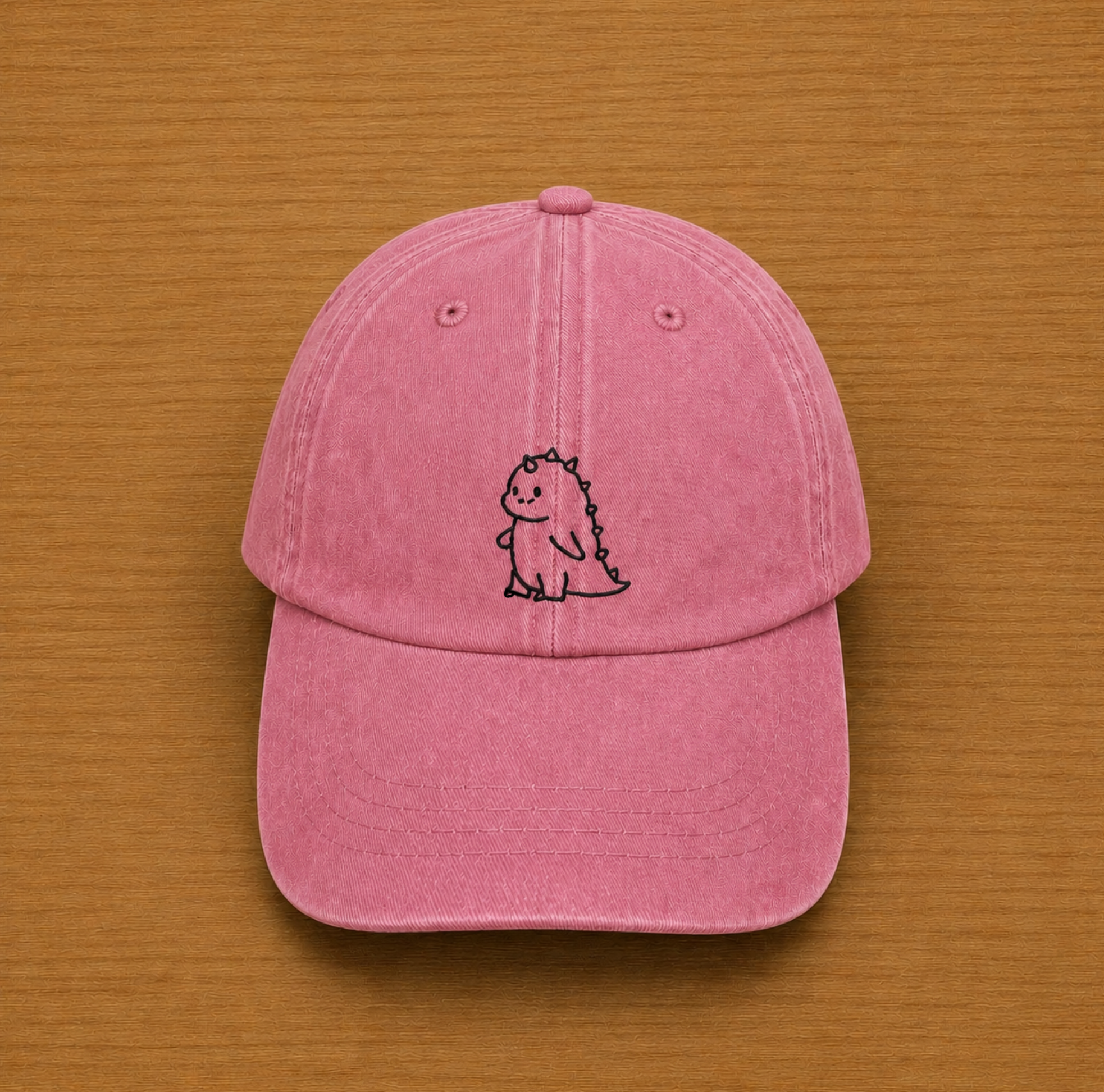 Gorra color rosa con dinosaurio